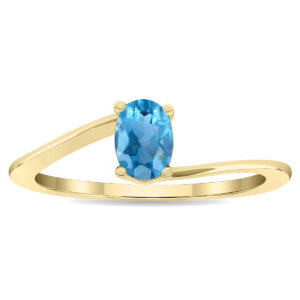 Women's Solitaire Oval Shaped Blue Topaz Wave Ring in 10K Yellow Gold- GRG61129BT